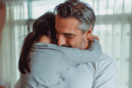 Dad hugging his daughter.